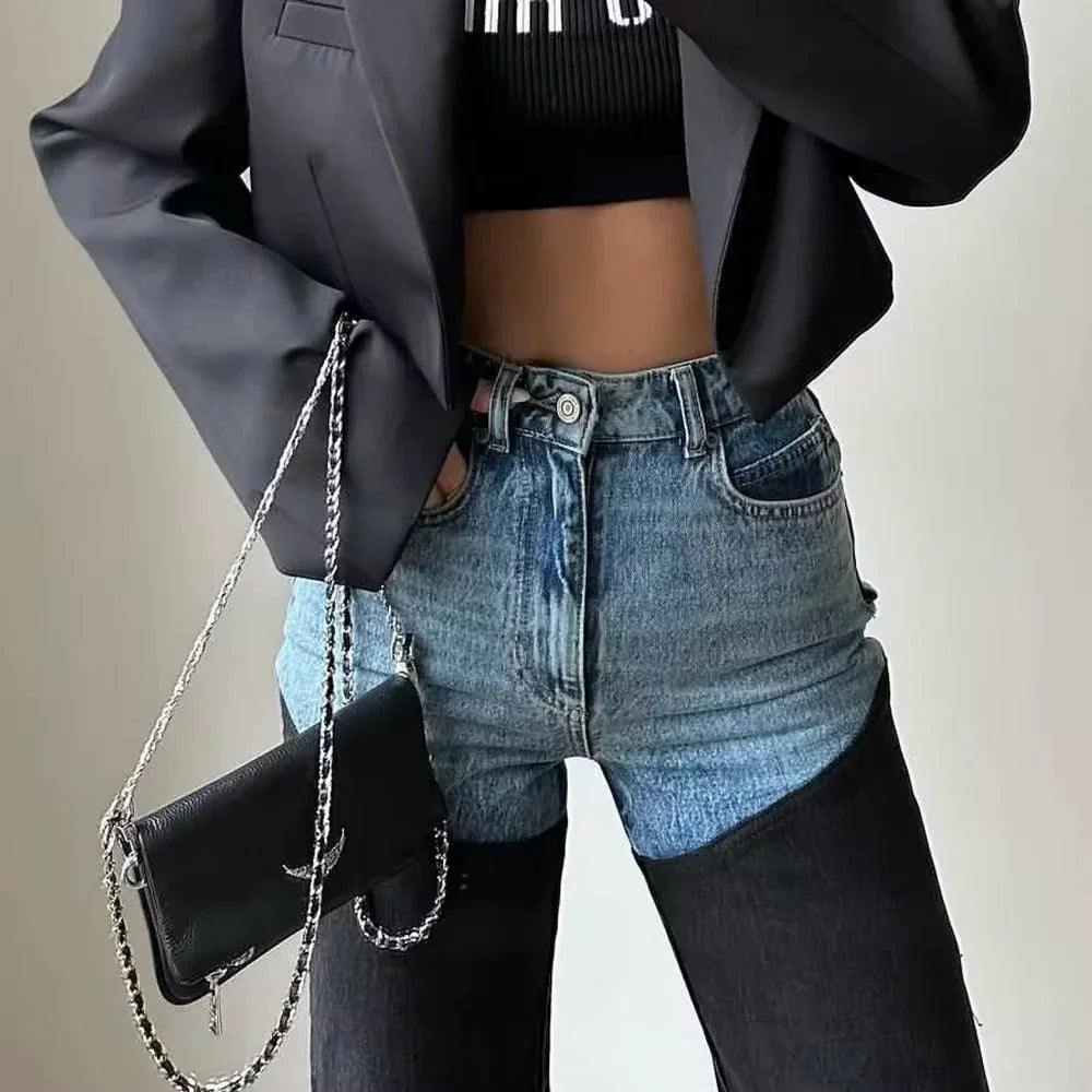 Trendy two-tone denim jeans with black crop top, blazer, and chain strap crossbody bag